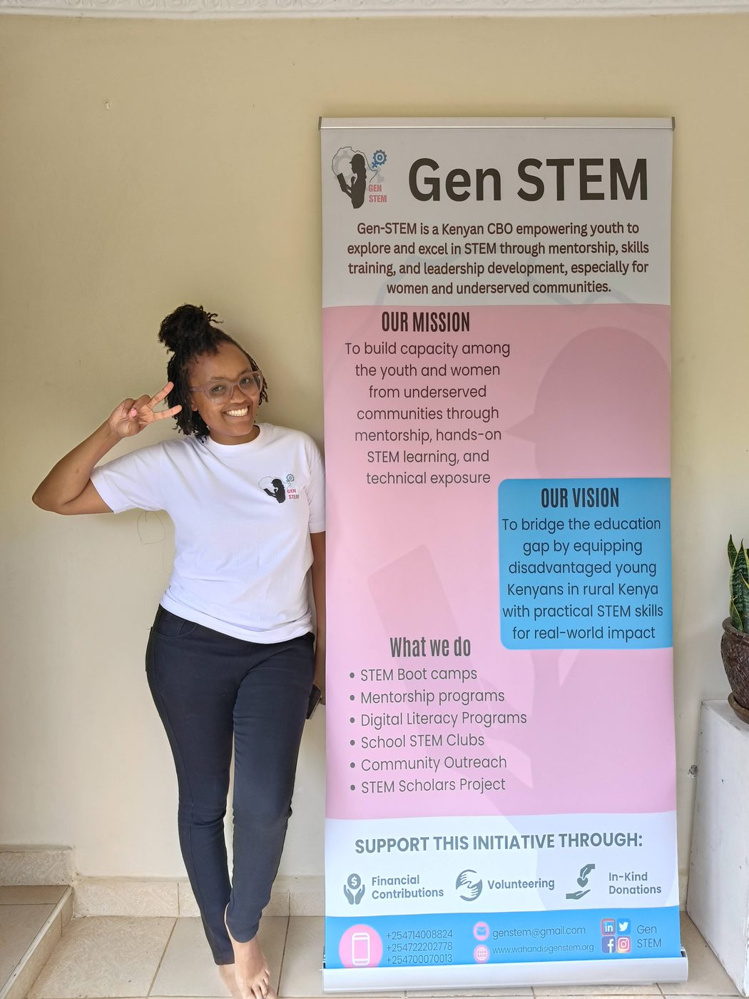 A GenSTEM girl presenting beside our banner