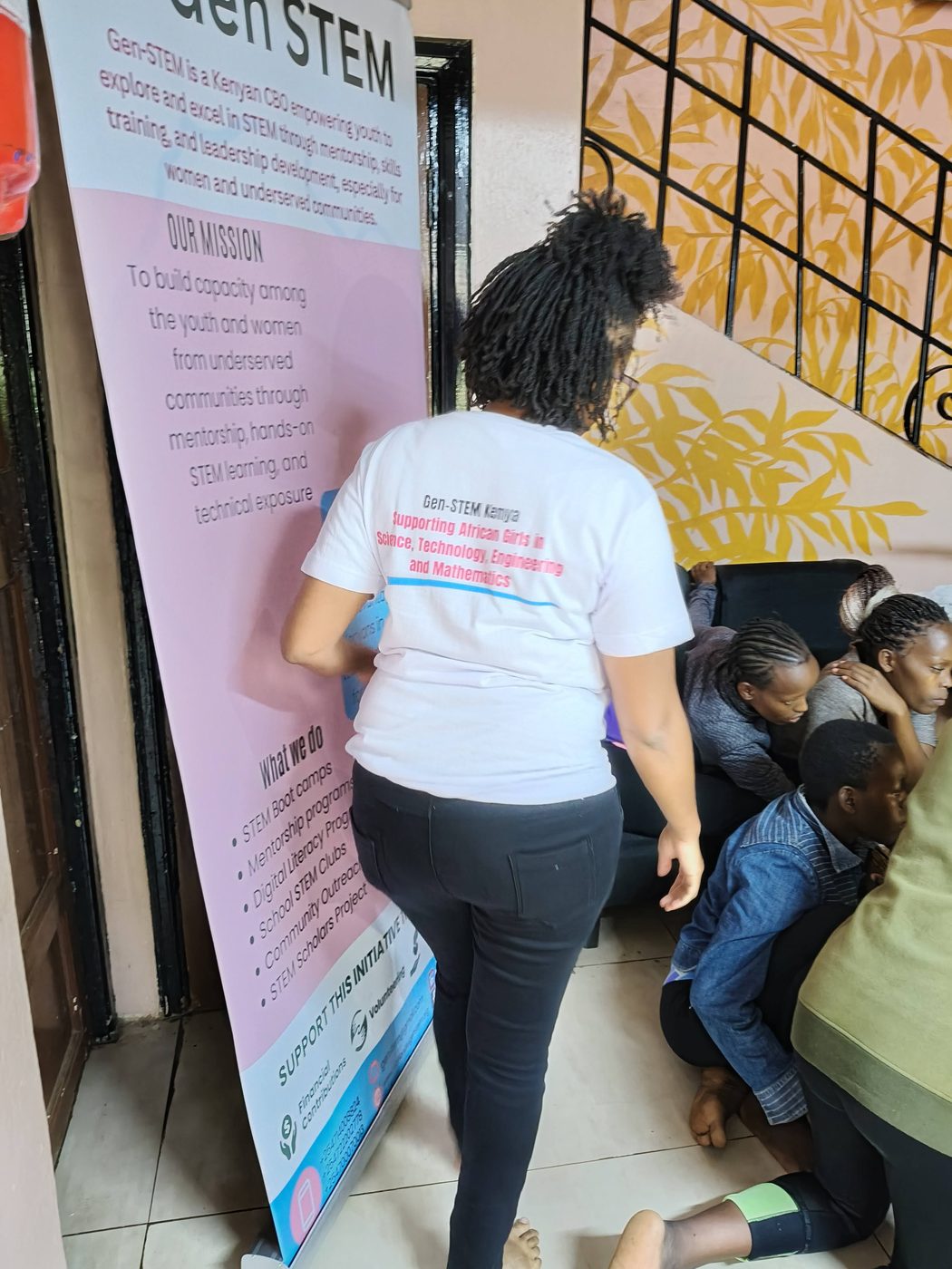 Two girls in GenSTEM t-shirts supporting each other